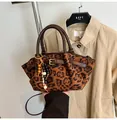Vintage leopard print handbag with leather handles and decorative wooden bead tassel - Leopard Print
