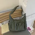 Deep green checkered crossbody cloud bag with adjustable blue-grey drawstring details - Green