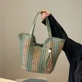 Large capacity straw tote bag in green contrast weave with bohemian tassel detail - Green