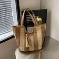 Beige and dark brown striped straw tote bag with braided handles and stylish tassels - Khaki