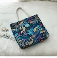 Detail of canvas tote bag with vibrant tropical leaf print and thick cotton rope handles - Vintage Blue Leaf