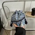 Detail of blue and white tweed bucket bag with long fringe tassels and drawstring - Blue And White Tweed Style / Blue Gold