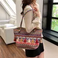 Ethnic bohemian woven tote bag with colorful geometric patterns and decorative tassels - Red