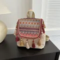 Ethnic bohemian backpack with purple geometric weaving and colorful tassel details - Red