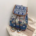 Detail of bohemian ethnic backpack featuring embroidered elephant pattern and colorful straps - Blue Elephant