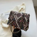 Ethnic style geometric woven crossbody bag with colorful patterns and gold chain strap - Black