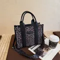 Leopard print woven tote bag with black leather handles and detachable shoulder strap - Black