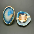Detail of irregular blue agate ring with golden trim and adjustable metal band - Lake Blue