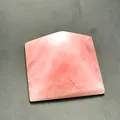 Detailed macro view of polished rose quartz pyramid with natural pink stone textures - 5cm