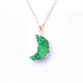 Macro detail of crescent moon pendant featuring green crystal druzy and rose gold plating - Green