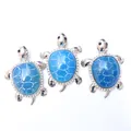 Detailed view of silver turtle pendants with blue shell pattern and crystal stones - Sapphire Blue