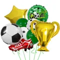 Close-up of champion trophy and soccer shoe foil balloons for sports party decor - Type A Trophy Red Shoes