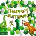 Dinosaur birthday party decoration set with green balloon arch, banners, and foil balloons - Single Digit Style