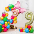 Detail of colorful latex balloons with donut, bow, and golden number 9 foil balloons - Number 9