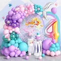 Mermaid birthday party decor with pastel balloon arch, silver fishtail, and number 4 balloon - 4th Birthday Style