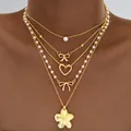 Collar de capas doradas con colgantes de corazón y lazo y perlas en piel oscura - Estilo de 5 Capas Mariposa Corazón Floral Perla Dorado (6606101HB)