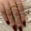 8-piece set of gold geometric hollow and woven rings with faux diamonds on model hand - 8-Piece Set (F34) / 8-piece Set / KC Gold