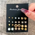 12-pair gold and pearl earring set featuring heart, star, and rhinestone stud designs - Full Diamond Heart Pearl Gold Stud Set (EJ18451)
