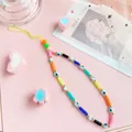 Close-up of rainbow polymer clay phone strap with evil eye beads on pink background - Rainbow Evil Eye Style (82837)