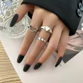 Close-up of three vintage silver heart rings worn on a hand with black matte nails - Hollow Heart Vintage Silver Cool Set (54962)