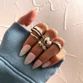 Vintage silver spade heart ring set of 6 pieces shown on a hand with blue sleeves - Antique Silver Heart Ripple Collection (5324802)