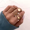 7-piece gold stackable ring set with heart and geometric designs on a model hand - One Size / Gold Minimalist Heart Bar 7-Piece Set (54414)