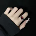 Détail d'une bague vintage en argent avec une pierre d'agate rouge en forme de bourgeon - Bague Creuse Ronde Look Rubis Rouge Vintage