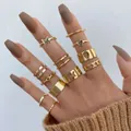 Set of 13 gold-toned butterfly and heart rings worn by a model in a stacked style - Gold Butterfly Heart Chain Ring 13-Piece Set (5463501) / Gold