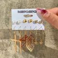 9-piece gold earring set featuring pearls, hearts, crosses, and bohemian leaf designs - Cross Leaf Star Gold Earring Set (5546)