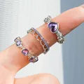Three-piece silver ring set with purple heart stones and crystals on a model's hand - Purple Heart Three Rings (5817203)