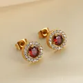 Close-up of 18K gold halo stud earrings with red zircon center and pave stone detail - Red Round Style (E0007) / Gold