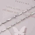 Detailed macro view of silver twisted diamond chain with secure lobster clasp finish - 3mm / 19cm / Steel
