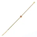Detail of gold bracelet with sparkling clear zircons and round red gemstone centerpiece - 18K Gold Round