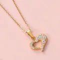 Macro shot of 18K gold plated hollow heart pendant necklace with shimmering cubic zirconia - 9-Stone Hollow Heart Style (N0113) / Gold