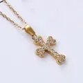 Macro shot of gold cross pendant with micro-pave cubic zirconia on delicate link chain - Fully Paved Cross (N0031)
