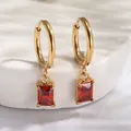 Detail of 18K gold plated hoop earrings with red rectangular zircon pendant detail - Red Zirconia