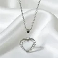 Silver tone heart necklace with hollow design and pavé cubic zirconia on silk background - Hollow Pave Heart Style (N0110S) / Steel