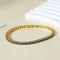 Macro detail of gold-plated tennis bracelet featuring black zircons and a secure fold-over clasp - Gold (Black Zirconia)