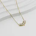 Detail of gold petal pendant necklace with marquise-cut cubic zirconia on white steps - Gold-White Zirconia