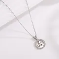 Macro detail of silver dragon pendant with hollow design and sparkling zircon pavé - Zodiac Dragon / Silver