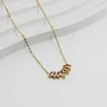 Macro shot of gold necklace featuring fan-shaped pink marquise zircon petal pendant - Gold-Pink Zirconia