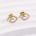 Close-up of golden spiral earrings with micro-pave cubic zirconia on white display - Eye Swirl Style (E0204G)