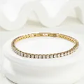 Detailed close-up of gold titanium steel tennis bracelet with sparkling zircon stones - 18cm / Gold Width 3