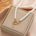 Elegant pearl necklace with golden OT buckle and crystal-encrusted letter L pendant - Gold L