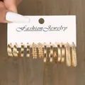 Detailed view of six pairs of gold hoop earrings with textured designs on display card - Triple Line Spiral Serrated Gold Earring Set (5742501HB)