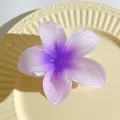 Detailed view of a 7cm purple plumeria hair claw clip on a textured ceramic plate - Gradient Purple Style (735005)
