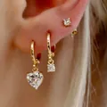 Three-piece gold plated earring set with heart and round zircon pendants on a model - 6399201HB/Gold Heart Hoop Earring Combo
