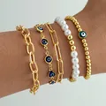 Five-piece gold evil eye and pearl layered bracelet set for bohemian fashion style - Evil Eye 5-Piece Set / Gold