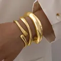 Three-piece set of chunky and slim gold geometric metal bangles on a female wrist - 3-Piece Set - Irregular Droplet (6526501HB) / Gold