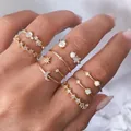 Stackable gold ring set featuring star moon motifs and white opal stones on fingers - Gold Opal Moon Star Flower Ring 7-Piece Set (5763) / Gold